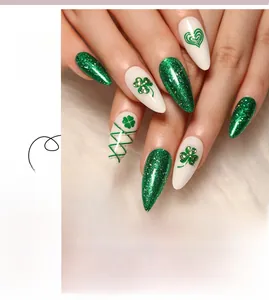Detail of St. Patrick's Day almond press-on nails with green glitter and shamrock patterns