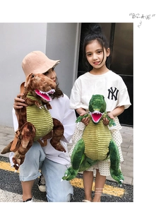 Detail showing brown and green dinosaur plush backpacks with adjustable straps