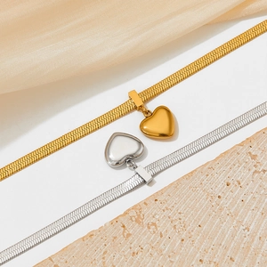 Flat snake chain bracelet with heart pendant in gold and silver stainless steel