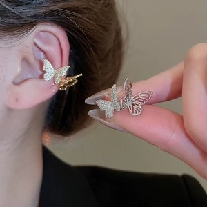 Sparkling zircon butterfly ear cuff in gold and silver finish with hollow-out metal wings