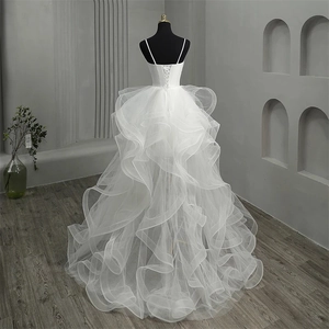 Elegant white high-low wedding dress with lace-up back and layered ruffled tulle skirt