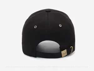 Detail view of the black baseball cap rear showing adjustable bronze buckle and strap