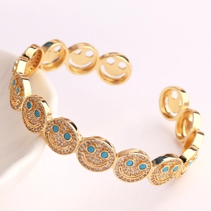 Vintage golden open cuff bracelet featuring turquoise eyes and zircon smiley faces