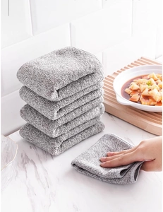 Stack of absorbent grey bamboo charcoal fiber kitchen towels on a marble countertop