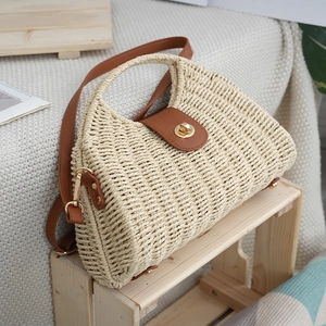 Retro woven beach bag with brown leather handles and gold twist lock closure for summer