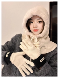 Detail of off-white knitted balaclava hood and matching gloves with contrast trim