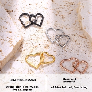 Detail of 316L stainless steel interlocking heart piercings in gold, silver and rose gold