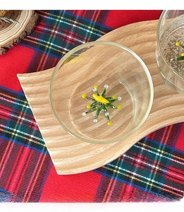 Close-up of a glass cup featuring a 3D green Christmas tree decoration at the bottom