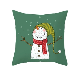 Detail of green Christmas pillowcase with cartoon snowman and snowflake illustration