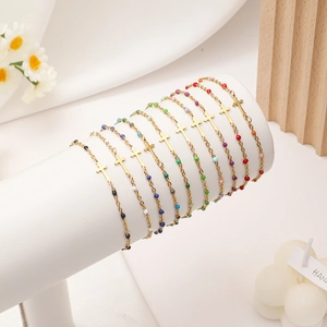 Colorful cross bead bracelet set made of gold stainless steel on white display stand