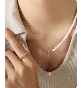 Close-up of freshwater pearl and gold plated titanium steel necklace with zircon ring