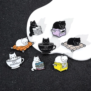 Detailed set of 8 cute black and white cartoon cat enamel pins on a dark background