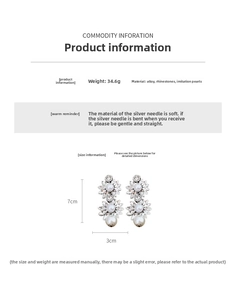 Macro shot of double floral earrings with sparkling rhinestones and drop pearls 7cm long