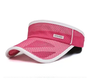 Close-up of pink breathable mesh sun visor hat with white Sport label and piping