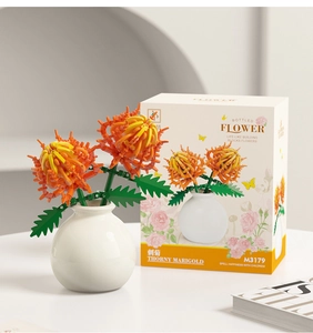 Macro view of Thorny Marigold building block flower with its white vase and retail box