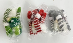 Three-pack of glowing Christmas gingerbread gnomes in striped plush packaging