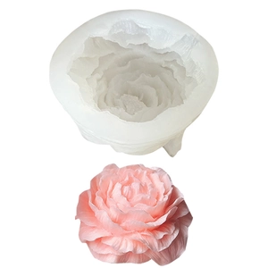 White silicone peony flower mold with detailed pink finished candle on white background