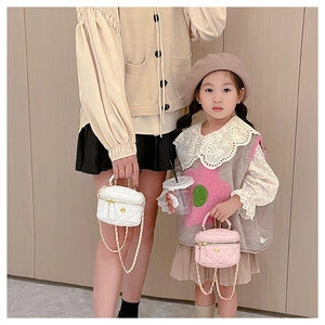 Quilted mini handbags in white and pink with golden chain straps for mothers and daughters