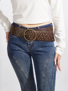 Close-up of brown PU leather belt with gold metal eyelets and a round buckle