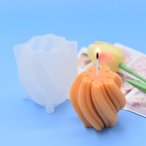 3D spiral wave sphere silicone mold and finished orange aromatherapy candle on blue background