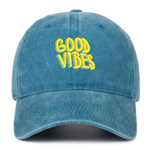 Detail of multi-colored GOOD VIBES embroidery on washed blue cotton baseball cap