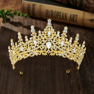Close-up of elegant gold crystal bridal crown on a rustic wooden table background