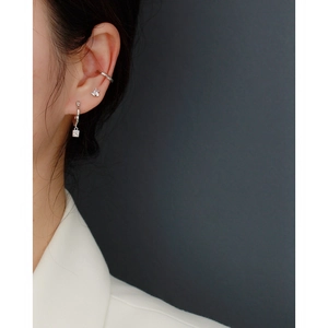 Close-up of S925 silver ear cuffs and irregular diamond earrings worn on a model