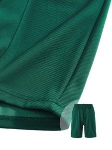 Close-up of dark green mesh texture and stitching on men's quick-dry sports shorts