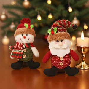 Plush Christmas tree decorations featuring Snowman and Santa Claus in a festive setting