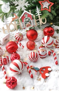 Detailed set of red and white Christmas ornaments with baubles and candy canes on snow