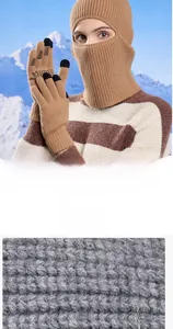 Close-up of thick khaki knit texture and touch screen gloves with warm balaclava hood