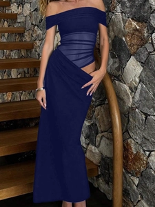Detailed view of elegant dark blue strapless dress with draped pleats and sheer mesh panels