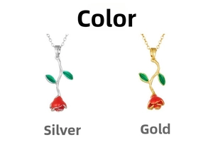 Detailed close-up of gold and silver rose flower pendants with red enamel and green leaves
