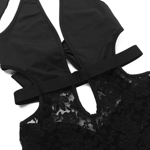Detail of black lace cutout jumpsuit featuring intricate floral patterns and elastic straps