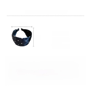 Detail view of dark blue velvet headband with dots pattern showing dimensions and weight