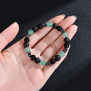 Handheld 8mm bead bracelet featuring green crystal, volcanic stone, and hematite beads