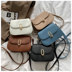 Flat lay of five vintage PU leather crossbody bags with gold buckles in multiple colors