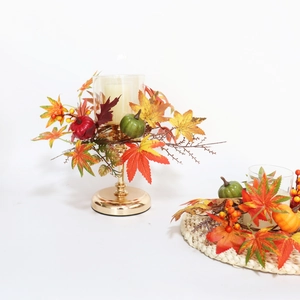 Autumn candle holder wreath with pumpkin, maple leaves, and berries on gold metal stand