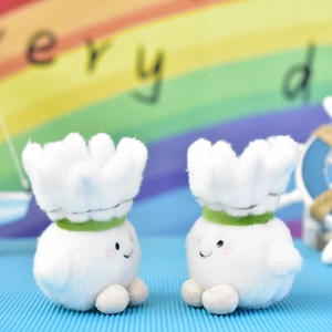 Close-up of two cute cartoon shuttlecock plush toys with smiling faces used as bag charms