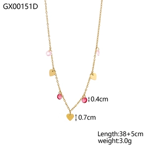 Gold chain necklace with pink and dark red faceted beads and heart charms on white background