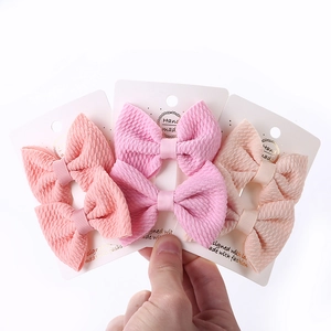 Three pairs of handmade textured bubble fabric bow hair clips for girls in pastel colors