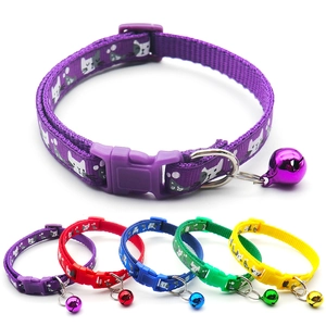 Close-up of adjustable nylon pet collars in five colors with bells and buckle details