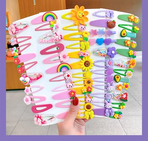 Detailed view of colorful cartoon hair clips featuring rainbows flowers and animals