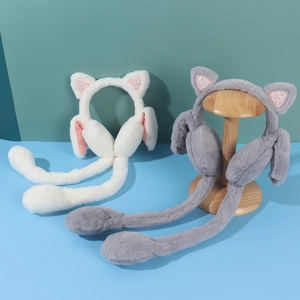 Detail of plush moving ear muffs with sequin cat ears and airbag paws in white and grey