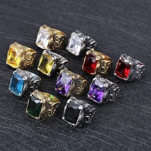 Close-up of vintage engraved steel rings with various colored rectangular gemstones