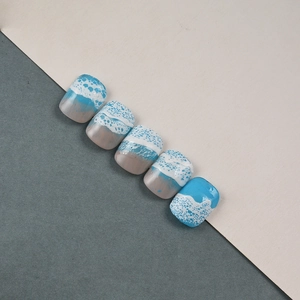 Detail of 5D blue ocean wave embossed nail stickers with white sea foam texture effect