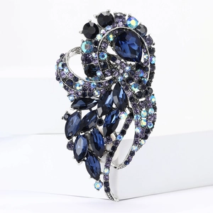 Detail of luxury vintage brooch with navy pear-cut crystals and antique silver plating