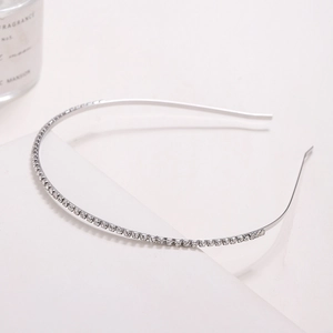Minimalist silver metal headband with sparkling rows of rhinestones on white steps