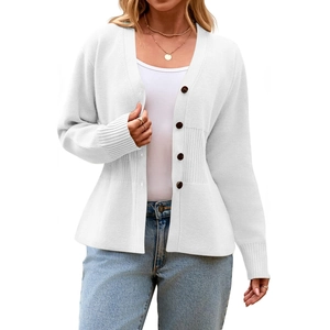 Close-up of white knit cardigan with dark brown buttons and vertical ribbed waist detail