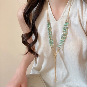 Ethnic style multi-layer beaded necklace with green crystals and long golden tassels